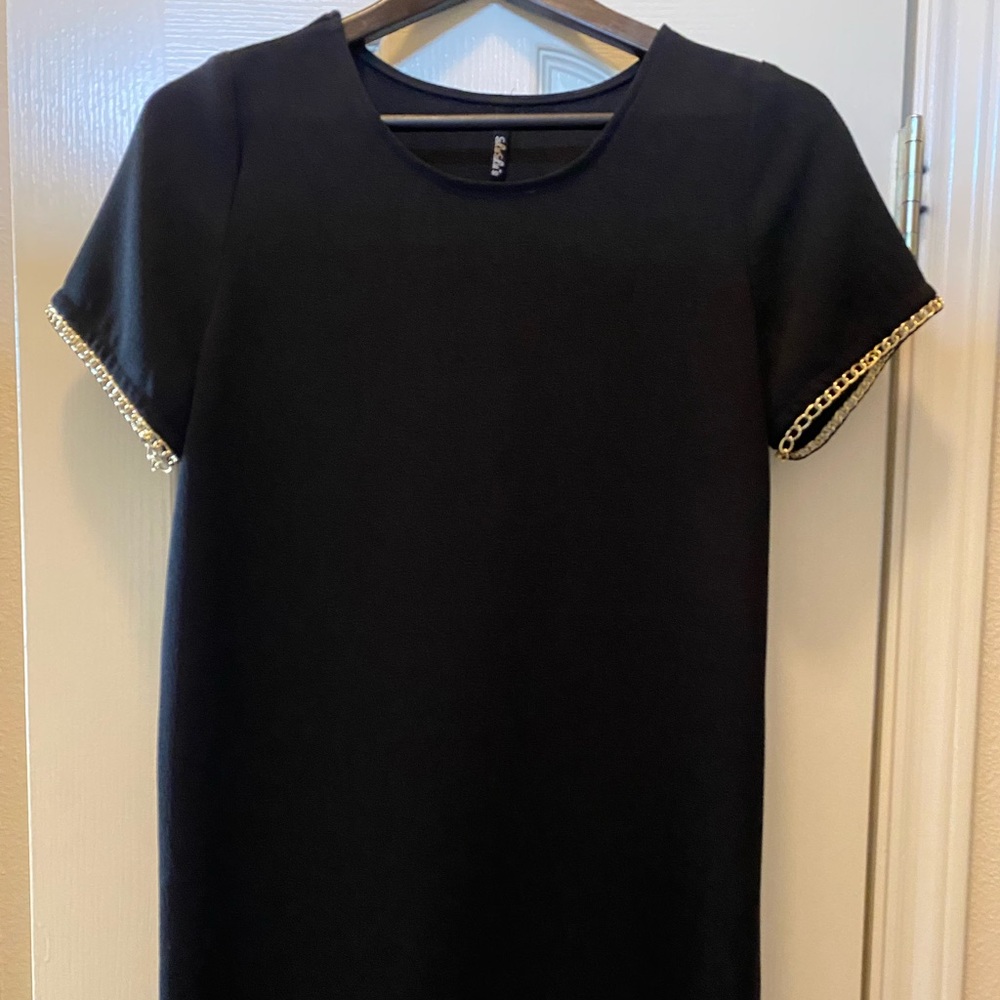 Black mini dress with gold chain trim by Lulu’s
